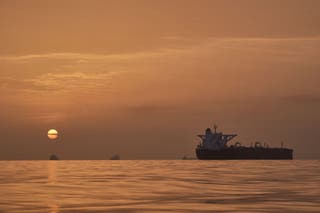 The sun rises behind tankers anchored in the Strait of Hormuz off the coast of Qeshm Island, Iran, Saturday, 18 April 2026